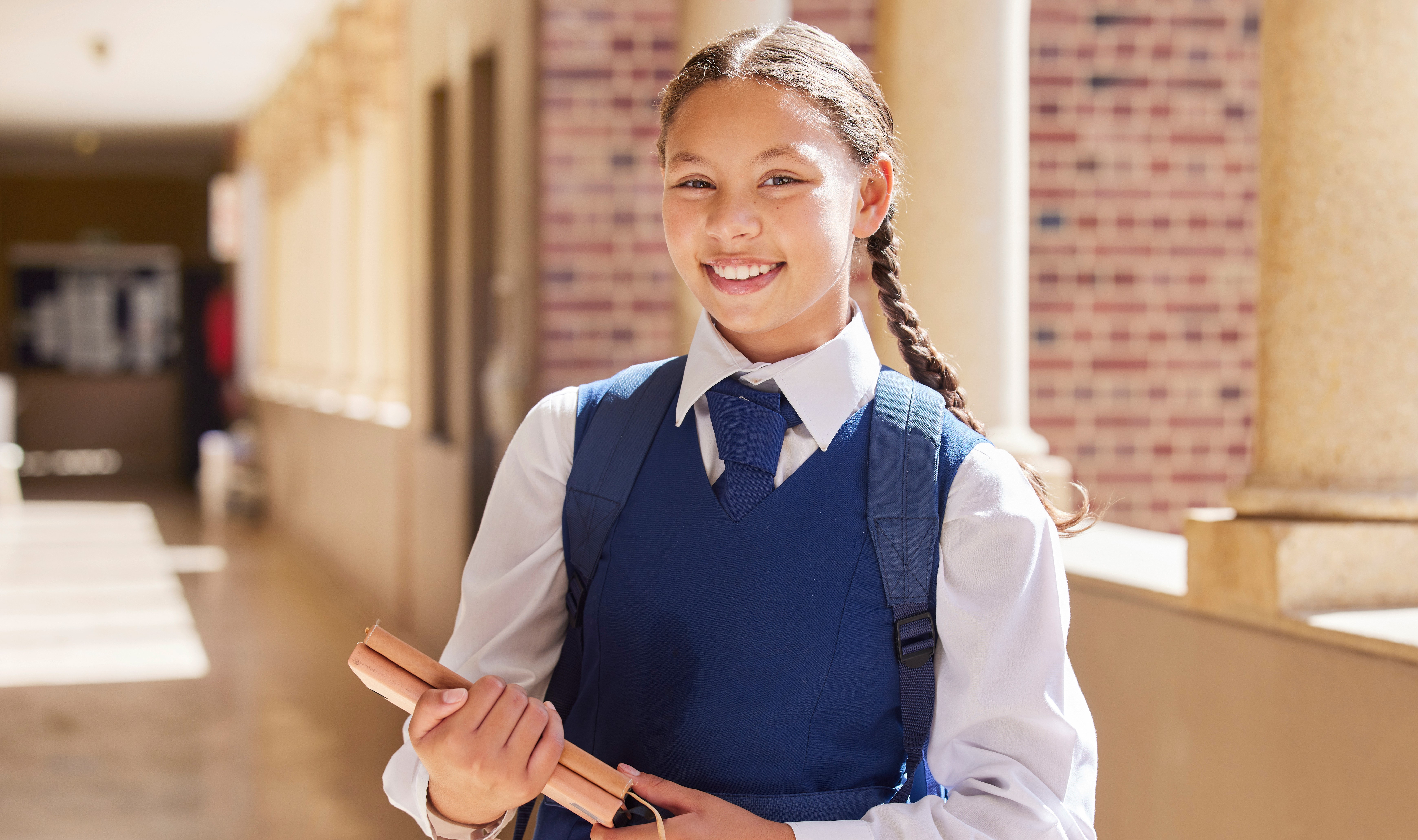 young girl with backpack walks to school