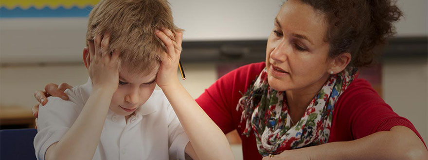 Frustrated boy with a teacher 