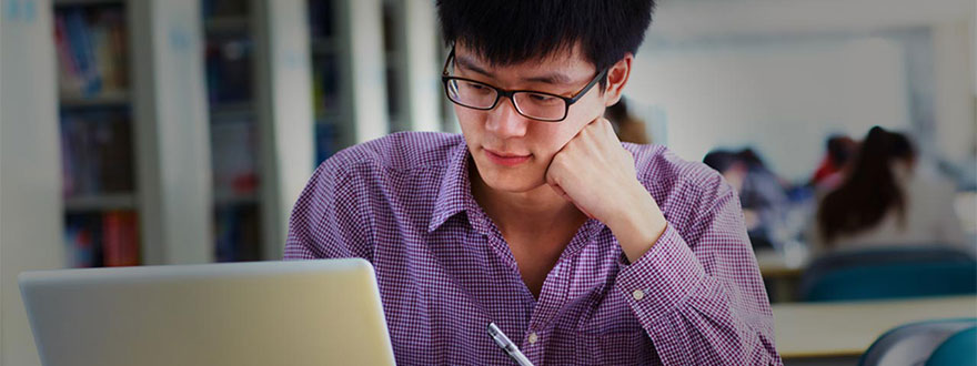 Adult with glasses on a laptop