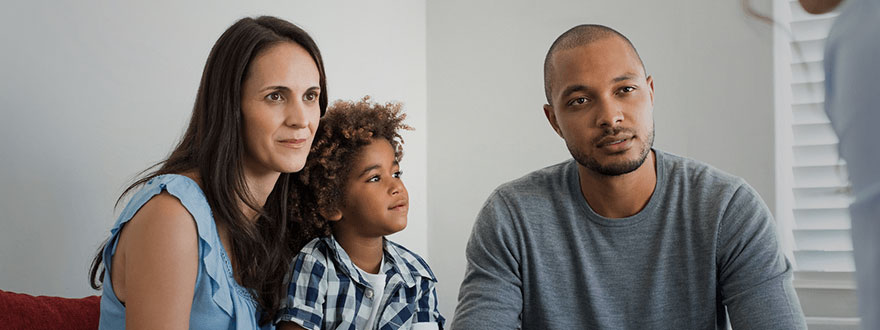 Concerned parents with their child and teacher