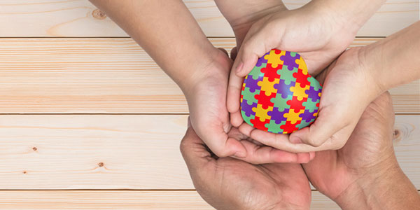 Hands cradling jigsaw pieces