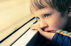 Boy with autism by a window