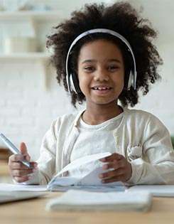 Girl with headphones with a laptop.