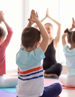 Class of kids doing yoga