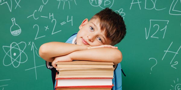 Boy resting on some books