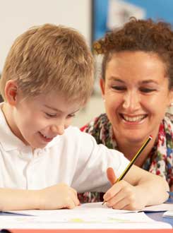 Teacher at a desk with child