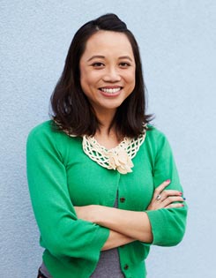 Smiling teacher with arms folded