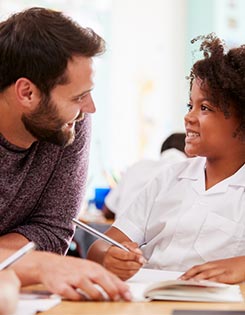 Child with a teacher in a classroom