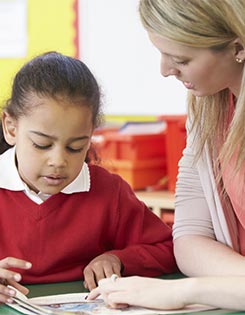 Child with a teacher ina  classroom