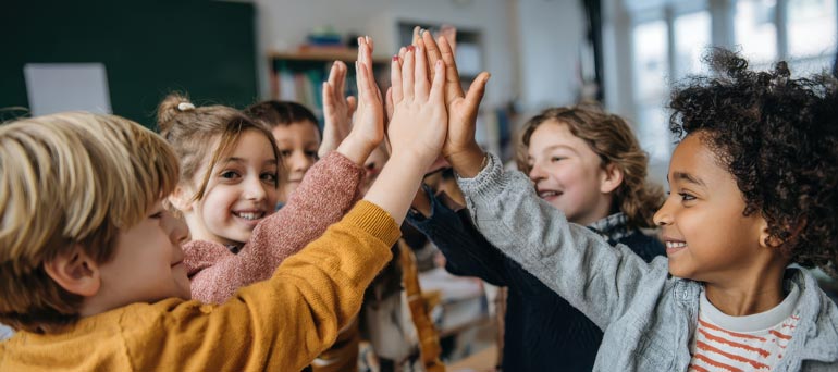Woman smiling on a laptop with headphones on