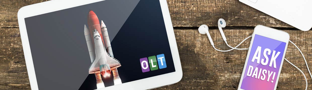 Tablet and phone on a table with a silhoette of a figure and some text saying Ask Daisy.